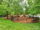 Community playground nestled among mature trees offers residents a safe, enclosed area for play at 13604 Morehouse St, Huntersville, NC 28078