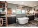Spa bathroom featuring a standalone tub, dual sinks, and natural light with a sauna at 13708 Huntson Park Ln, Huntersville, NC 28078