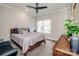 Bright bedroom features a ceiling fan, plush carpet, and a sunny window at 13708 Huntson Park Ln, Huntersville, NC 28078