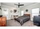 Bedroom features a queen bed, ceiling fan, modern decor, and neutral walls at 13708 Huntson Park Ln, Huntersville, NC 28078