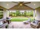 Spacious covered patio with a grill, lounge chairs, and a peaceful view of the backyard at 13708 Huntson Park Ln, Huntersville, NC 28078