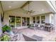 Large covered patio featuring comfortable seating, a grill, and sliding glass doors to the indoors at 13708 Huntson Park Ln, Huntersville, NC 28078