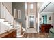 Welcoming foyer boasts high ceilings, stylish decor, and an elegant staircase with wooden accents at 13708 Huntson Park Ln, Huntersville, NC 28078