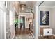 Inviting foyer with hardwood floors, a staircase, and stylish decor creating a welcoming atmosphere at 13708 Huntson Park Ln, Huntersville, NC 28078