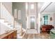 Inviting two-story foyer with a staircase, grand chandelier, and neutral color palette at 13708 Huntson Park Ln, Huntersville, NC 28078