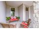 Inviting front porch with comfortable seating and a view of the well-manicured neighborhood at 13708 Huntson Park Ln, Huntersville, NC 28078
