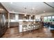 Bright kitchen features a large center island with barstool seating, stainless steel appliances, and lots of cabinets at 13708 Huntson Park Ln, Huntersville, NC 28078
