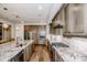A modern kitchen featuring stainless steel appliances, wooden cabinets, granite countertops and hardwood floors at 13708 Huntson Park Ln, Huntersville, NC 28078