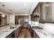 Modern kitchen featuring granite countertops, stainless steel appliances, and beautiful hardwood floors at 13708 Huntson Park Ln, Huntersville, NC 28078