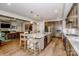A modern eat-in kitchen with stainless steel appliances, a large island, granite countertops and hardwood floors at 13708 Huntson Park Ln, Huntersville, NC 28078