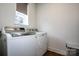 Convenient laundry room equipped with modern washer and dryer units and a window for ventilation at 13708 Huntson Park Ln, Huntersville, NC 28078
