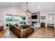 Open living room with fireplace, hardwood floors, and access to outdoor patio at 13708 Huntson Park Ln, Huntersville, NC 28078