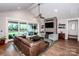 Inviting living room with a stone fireplace, large sliding doors to the patio, and vaulted ceiling at 13708 Huntson Park Ln, Huntersville, NC 28078