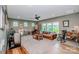 A cozy living room featuring neutral decor, comfortable seating, and natural light at 13708 Huntson Park Ln, Huntersville, NC 28078