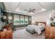 A bright main bedroom with a ceiling fan, large windows, and neutral decor at 13708 Huntson Park Ln, Huntersville, NC 28078