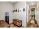 A mudroom featuring hooks, a storage bench and wood floors at 13708 Huntson Park Ln, Huntersville, NC 28078