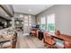 Bright office space with wood desks and a view to an adjoining living room at 13708 Huntson Park Ln, Huntersville, NC 28078