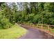 Charming wooded property with a paved path and a wooden bridge at 13708 Huntson Park Ln, Huntersville, NC 28078