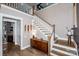 Elegant staircase with wooden treads, white risers, and natural light at 13708 Huntson Park Ln, Huntersville, NC 28078