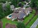 Stunning aerial view of a home with a pool, lush landscaping, and solar panels at 1501 Alydar Ct, Waxhaw, NC 28173