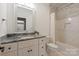 Updated bathroom featuring a white vanity with granite countertop and a shower/tub combo at 1501 Alydar Ct, Waxhaw, NC 28173