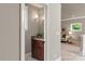 Charming powder room featuring a wood vanity, granite countertop, and stylish wall sconce lighting at 1501 Alydar Ct, Waxhaw, NC 28173