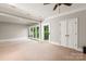 Spacious bedroom with a ceiling fan, plush carpet, and doors to a balcony at 1501 Alydar Ct, Waxhaw, NC 28173