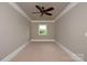 Minimalist bedroom with a ceiling fan, neutral carpet and a large window with views at 1501 Alydar Ct, Waxhaw, NC 28173