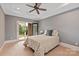 Bright bedroom with tray ceiling, carpet, sliding door, and a queen size bed at 1501 Alydar Ct, Waxhaw, NC 28173