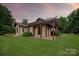 Charming home featuring a backyard pergola and well-manicured lawn at 1501 Alydar Ct, Waxhaw, NC 28173