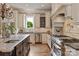 Chef's kitchen with custom cabinetry, stainless steel appliances, and granite countertops at 1501 Alydar Ct, Waxhaw, NC 28173