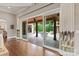Bright living room with hardwood floors and sliding glass doors to the covered outdoor living area with pool at 1501 Alydar Ct, Waxhaw, NC 28173