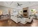 Cozy living room with a stone fireplace, coffered ceiling, and hardwood floors at 1501 Alydar Ct, Waxhaw, NC 28173