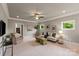 Spacious living room with neutral decor, crown molding, recessed lights, large windows, and comfortable seating at 1501 Alydar Ct, Waxhaw, NC 28173