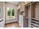 Spacious walk-in closet featuring custom shelves, drawers, and natural lighting through the window at 1501 Alydar Ct, Waxhaw, NC 28173