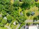 Aerial view of the home and surrounding neighborhood, showcasing mature trees at 1528 Avondale Dr, Statesville, NC 28625