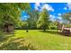 This sprawling backyard includes a deck, shed, mature trees and green lawn at 1528 Avondale Dr, Statesville, NC 28625