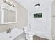 Neat bathroom featuring modern vanity, tub with shower, window, and fixtures at 1528 Avondale Dr, Statesville, NC 28625