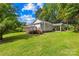 Exterior view of home featuring a deck, a carport, and lush greenery at 1528 Avondale Dr, Statesville, NC 28625