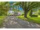 Lovely one-story home with a covered porch and a long gravel driveway surrounded by mature trees at 1528 Avondale Dr, Statesville, NC 28625