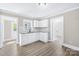 Well-lit kitchen with white cabinets, granite countertops, and modern flooring at 1528 Avondale Dr, Statesville, NC 28625