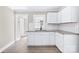 Bright kitchen featuring white cabinets, granite counters, stainless steel faucet, and subway tile backsplash at 1528 Avondale Dr, Statesville, NC 28625
