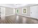 Bright living room featuring modern flooring, white trim, and ample natural light through windows at 1528 Avondale Dr, Statesville, NC 28625