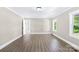 Bright living room featuring modern flooring, white trim, and natural light through a window at 1528 Avondale Dr, Statesville, NC 28625