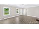 Bright living room featuring modern flooring, white trim, and plenty of natural light at 1528 Avondale Dr, Statesville, NC 28625