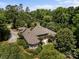 An aerial shot shows a private residence surrounded by dense trees and a well-manicured lawn at 1629 Southpoint Ln, New London, NC 28127