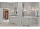 Elegant bathroom features double vanity with white cabinets, framed mirrors and decorative fixtures at 1629 Southpoint Ln, New London, NC 28127