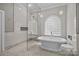 Beautiful bathroom featuring a freestanding tub, glass shower, and lots of bright, natural light at 1629 Southpoint Ln, New London, NC 28127