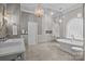 Luxurious bathroom showcasing a freestanding tub, glass shower, and stylish fixtures, creating a spa-like retreat at 1629 Southpoint Ln, New London, NC 28127