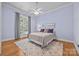 Comfortable bedroom with a ceiling fan, large window with natural light, and a patterned rug at 1629 Southpoint Ln, New London, NC 28127